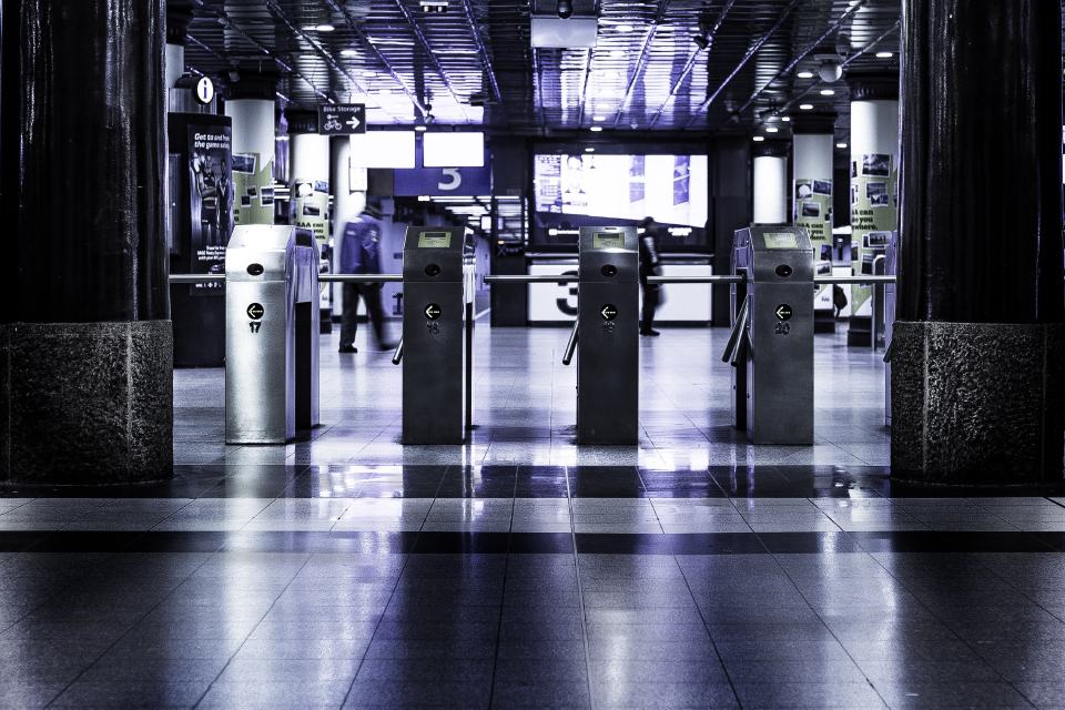 Dark airport access gates suggesting secure market entry and global movement.