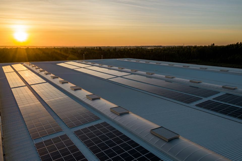 Solar infrastructure at sunset representing energy and real-economy projects.